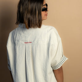 stone-colored Camp Shirt, a beige short-sleeve button-up featuring classic plaid trim