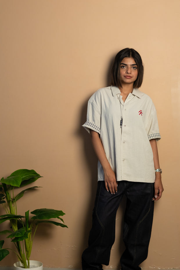 stone-colored Camp Shirt, a beige short-sleeve button-up featuring classic plaid trim