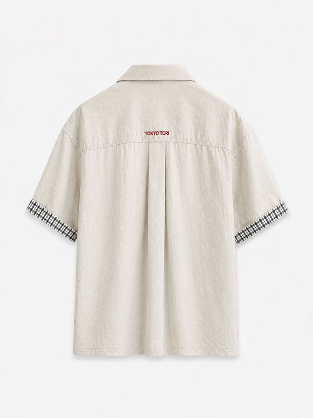 stone-colored Camp Shirt, a beige short-sleeve button-up featuring classic plaid trim